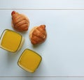 Concept: healthy food, healthy breakfast. Top view. Orange juice and croissants. on a blue background.
