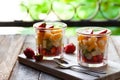 Concept of healthy food, clean eating. Low calories colorful sweet summer dessert. Homemade simple fruit salad in two glasses, Royalty Free Stock Photo