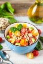 Concept of healthy food, clean eating, low calories delicious meal. Salad with quinoa and fresh vegetables with olive oil in blue