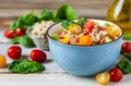 Concept of healthy food, clean eating, low calories delicious meal. Salad with quinoa and fresh vegetables with olive oil in blue Royalty Free Stock Photo