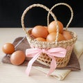 Concept healthy gift, Fresh brown chicken eggs in basket gift set on wooden table Royalty Free Stock Photo
