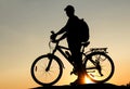 Concept of healthy lifestyle. Silhouette of cyclists at sunset