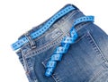 Concept of healthy lifestyle, weight loss. Jeans with measuring tape Royalty Free Stock Photo