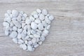 Concept heart shaped stones pile on wooden table. Royalty Free Stock Photo