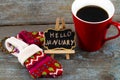 Concept HELLO january message on blackboard with a Cup of coffee Royalty Free Stock Photo