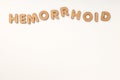 Concept of hemorrhoids with wooden letters on white background