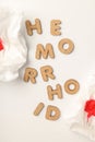 Concept of hemorrhoids with wooden letters on white background