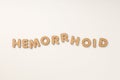 Concept of hemorrhoids with wooden letters on white background