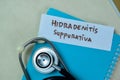 Concept of Hidradenitis Suppurativa write on sticky notes with stethoscope isolated on Wooden Table