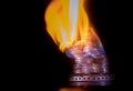 Coins on fire. The concept of high prices for natural gas. Royalty Free Stock Photo