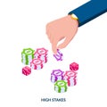 The concept of high stakes. Human hand with high denomination casino chips and dice.