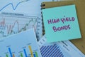 Concept of High Yield Bonds write on sticky notes isolated on Wooden Table