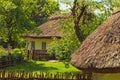 Concept of historical buildings in ancient Ukrainian village. Reconstruction of an ancient clay house with front yard Royalty Free Stock Photo