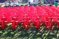 The concept of holding mass celebrations in the open air. Rows of plastic pink chairs on a sunny day, the shadow of objects