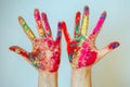 Concept of Holi, Indian festival of colors. Image of women`s hands on white background, close-up. Powdered paints on palms Royalty Free Stock Photo