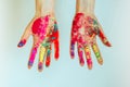 Concept of Holi, Indian festival of colors. Image of women`s hands on white background, close-up. Powdered paints on palms Royalty Free Stock Photo