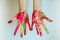 Concept of Holi, Indian festival of colors. Image of women`s hands on white background, close-up. Powdered paints on palms Royalty Free Stock Photo