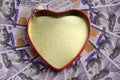 Concept for the holiday St. Valentine`s Day, a gift for the wedding, finance and love. A golden heart box with a red outline agai Royalty Free Stock Photo