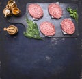 Concept of home cooking chops of marble beef four cutlets are laid out on vintage cutting board on blue rustic wooden background