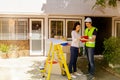 Architects and young homeowners consult home improvement work and calculate costs before work. Royalty Free Stock Photo