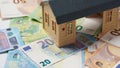 Concept of home ownership. New house and Euro money as a background. Invest in real estate Royalty Free Stock Photo