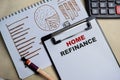 Concept of Home refinance write on clipboard isolated on Wooden Table Royalty Free Stock Photo