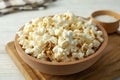 Concept of homemade salt popcorn on white wooden background