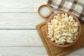 Concept of homemade salt popcorn on white wooden background