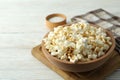 Concept of homemade salt popcorn on white wooden background