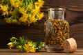 Concept of homeopathy and herbal treatment - dried Hypericum perforatum know as tutsan or Saint-Johns-wort in a bottle