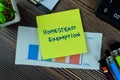 Concept of Homestead Exemption write on sticky notes isolated on Wooden Table