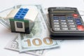 The concept of housing lending. Money, calculator, toy house. Royalty Free Stock Photo