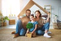 Concept housing   young family. Mother father and child in new house with  roof at home Royalty Free Stock Photo