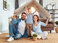 Concept housing   young family. Mother father and child in new house with  roof at home Royalty Free Stock Photo
