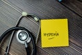 Concept of Hypoxia write on sticky notes with stethoscope isolated on Wooden Table