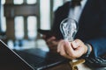 Concept of idea for business, business people holding light blub on desk. Royalty Free Stock Photo