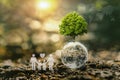 concept idea eco environment. tree growing on globe glass with world map and family icon in nature Royalty Free Stock Photo