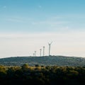 Concept idea eco power energy. wind turbine on hill with sunset Royalty Free Stock Photo