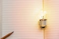 Concept idea. Growing light bulb on vintage book with pencil. Co Royalty Free Stock Photo