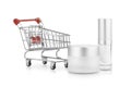 Concept idea shopping, mock up a empty container cream jar and a bottle of cosmetic cream and a small shopping cart.