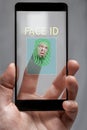 The concept of identification . the system reads the fingerprints of the phone owner. the human face is depicted on the tip of Royalty Free Stock Photo