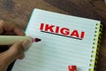 Concept of IKIGAI write on book on Wooden Table