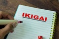 Concept of IKIGAI write on book  on Wooden Table Royalty Free Stock Photo
