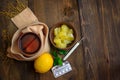 Concept illness, colds, cure, fall and winter. Tea with lemon, thermometer, pills and a knitted scarf. Top View