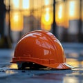 Close-up of a construction helmet on the background of a construction site and sunset. Royalty Free Stock Photo