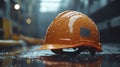 Close-up of a construction helmet on the background of a construction site and sunset. Royalty Free Stock Photo