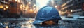 Close-up of a construction helmet on the background of a construction site and sunset. Royalty Free Stock Photo