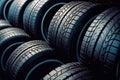 New tires pile on a dark background. Tyre fitting background. Stock of car tires. Generative AI Royalty Free Stock Photo