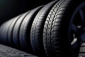 New tires pile on a dark background. Tyre fitting background. Stock of car tires. Generative AI Royalty Free Stock Photo