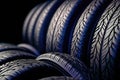 New tires pile on a dark background. Tyre fitting background. Stock of car tires. Generative AI Royalty Free Stock Photo